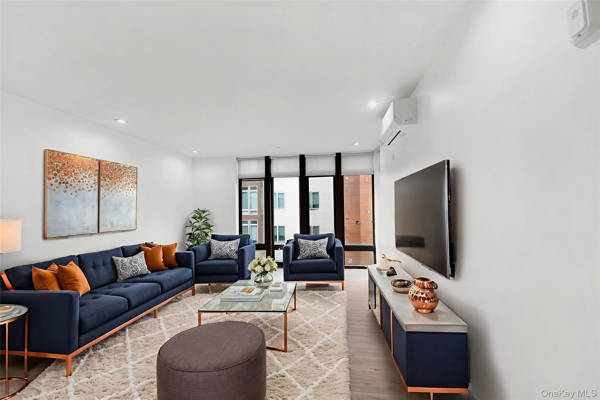 Living room featuring floor to ceiling windows, wood finished floors, and recessed lighting Living room featuring floor to ceiling windows, wood finished floors, and recessed lighting
