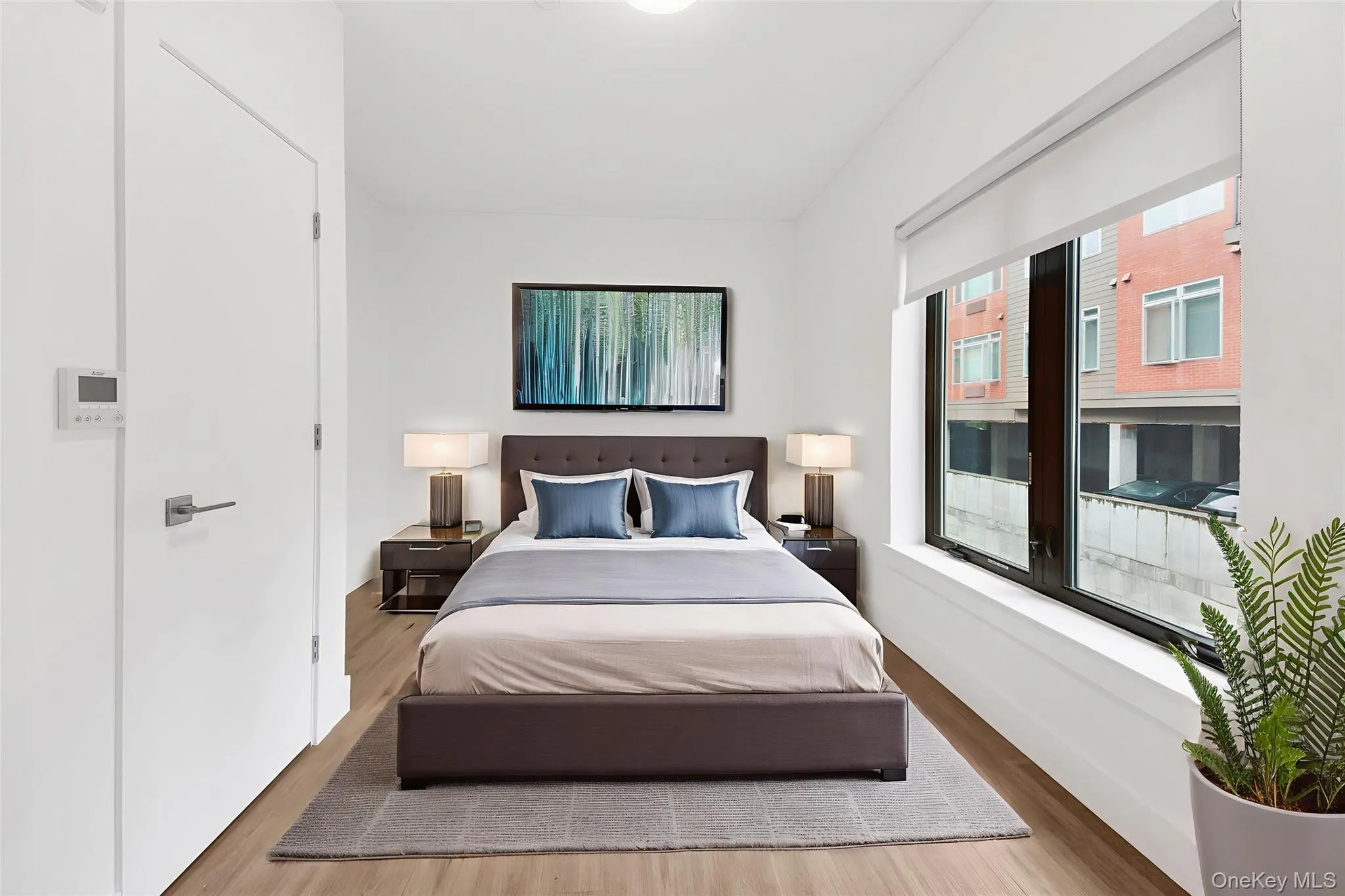 Bedroom with wood finished floors and baseboards Bedroom with wood finished floors and baseboards