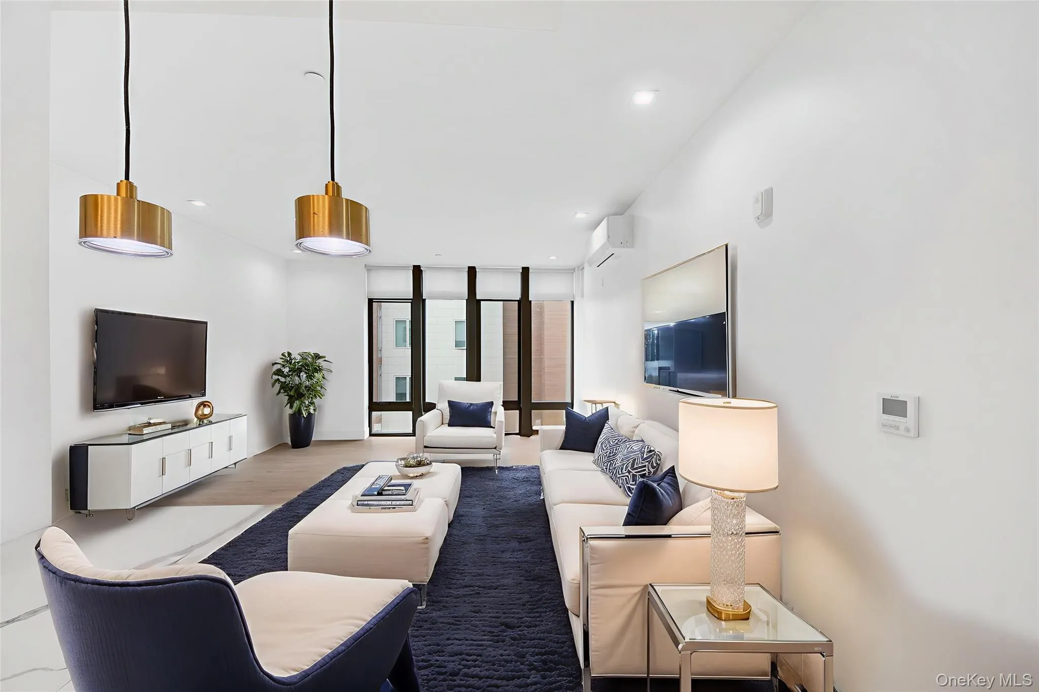 Living room featuring expansive windows, wood finished floors, and recessed lighting Living room featuring expansive windows, wood finished floors, and recessed lighting