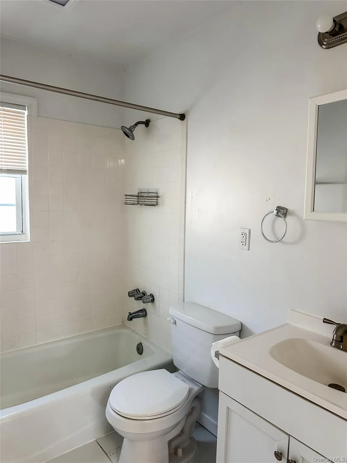 Bathroom with tub / shower combination, vanity, and tile patterned flooring Bathroom with tub / shower combination, vanity, and tile patterned flooring