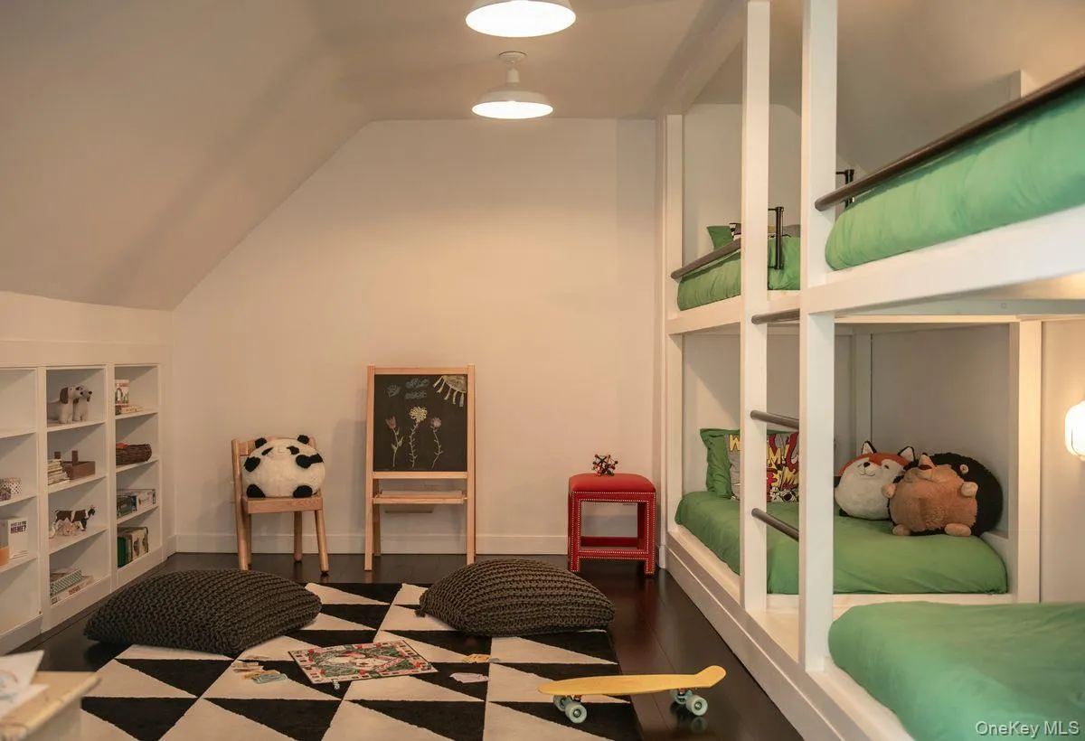Bedroom featuring wood finished floors and lofted ceiling Bedroom featuring wood finished floors and lofted ceiling
