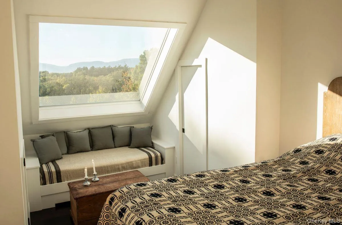 Bedroom featuring a skylight and multiple windows Bedroom featuring a skylight and multiple windows