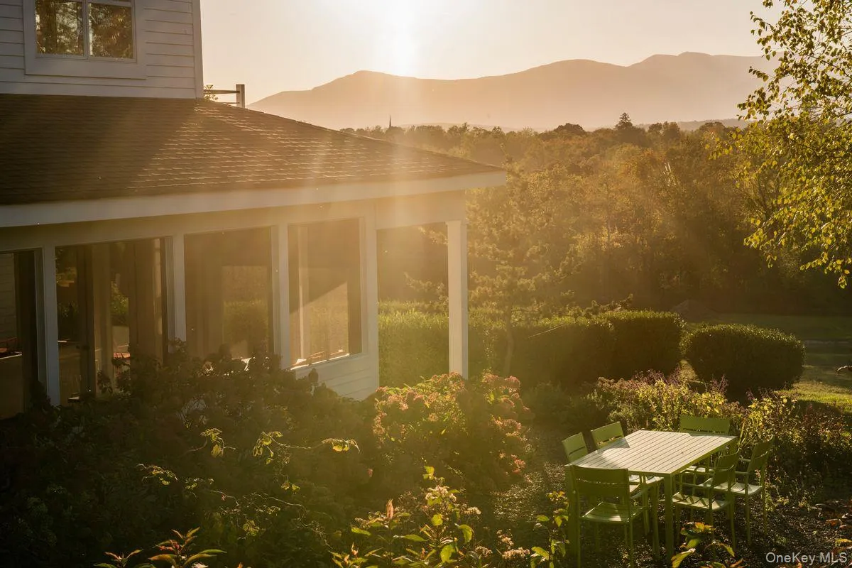 Property exterior at dusk featuring a mountain view and roof with shingles Property exterior at dusk featuring a mountain view and roof with shingles