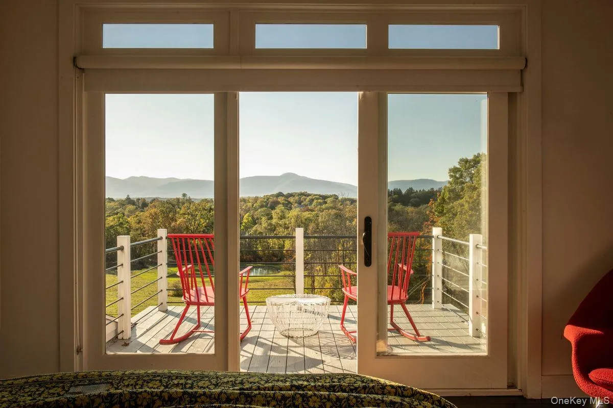 Doorway with a mountain view and view of wooded area Doorway with a mountain view and view of wooded area