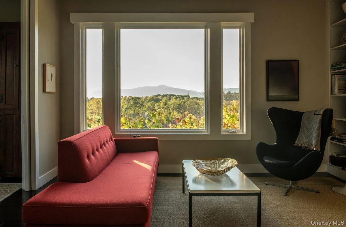 Living area featuring plenty of natural light and a mountain view Living area featuring plenty of natural light and a mountain view