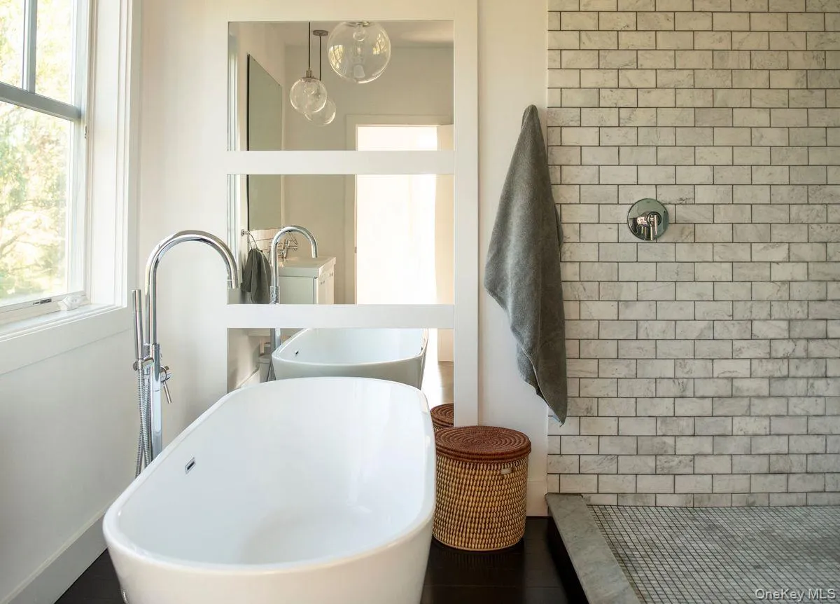 Full bathroom with healthy amount of natural light, a shower stall, and a freestanding bath Full bathroom with healthy amount of natural light, a shower stall, and a freestanding bath