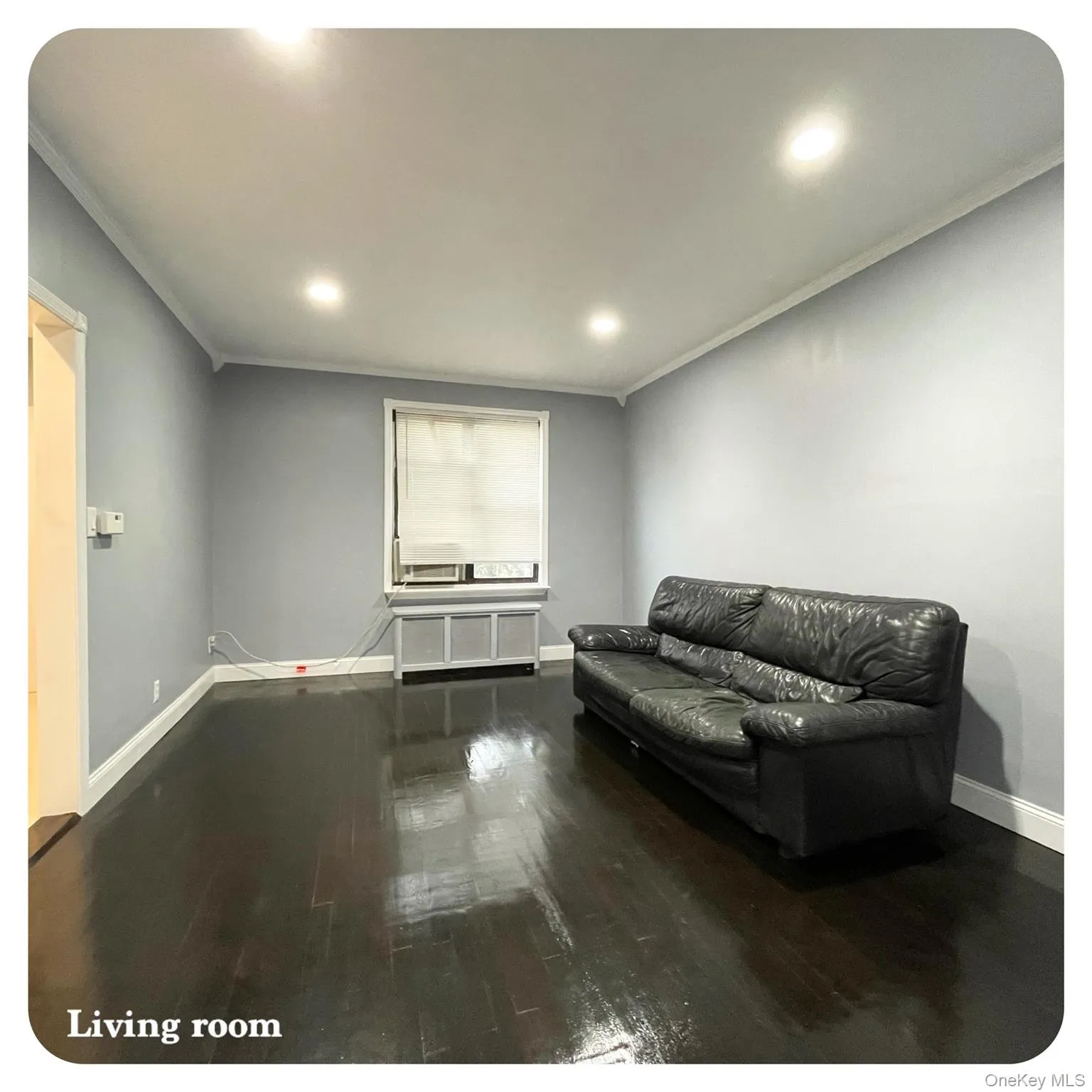 Living area with crown molding, dark wood-style flooring, and recessed lighting Living area with crown molding, dark wood-style flooring, and recessed lighting