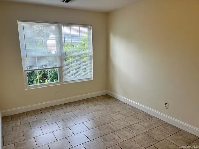 Empty room featuring light tile patterned flooring Empty room featuring light tile patterned flooring