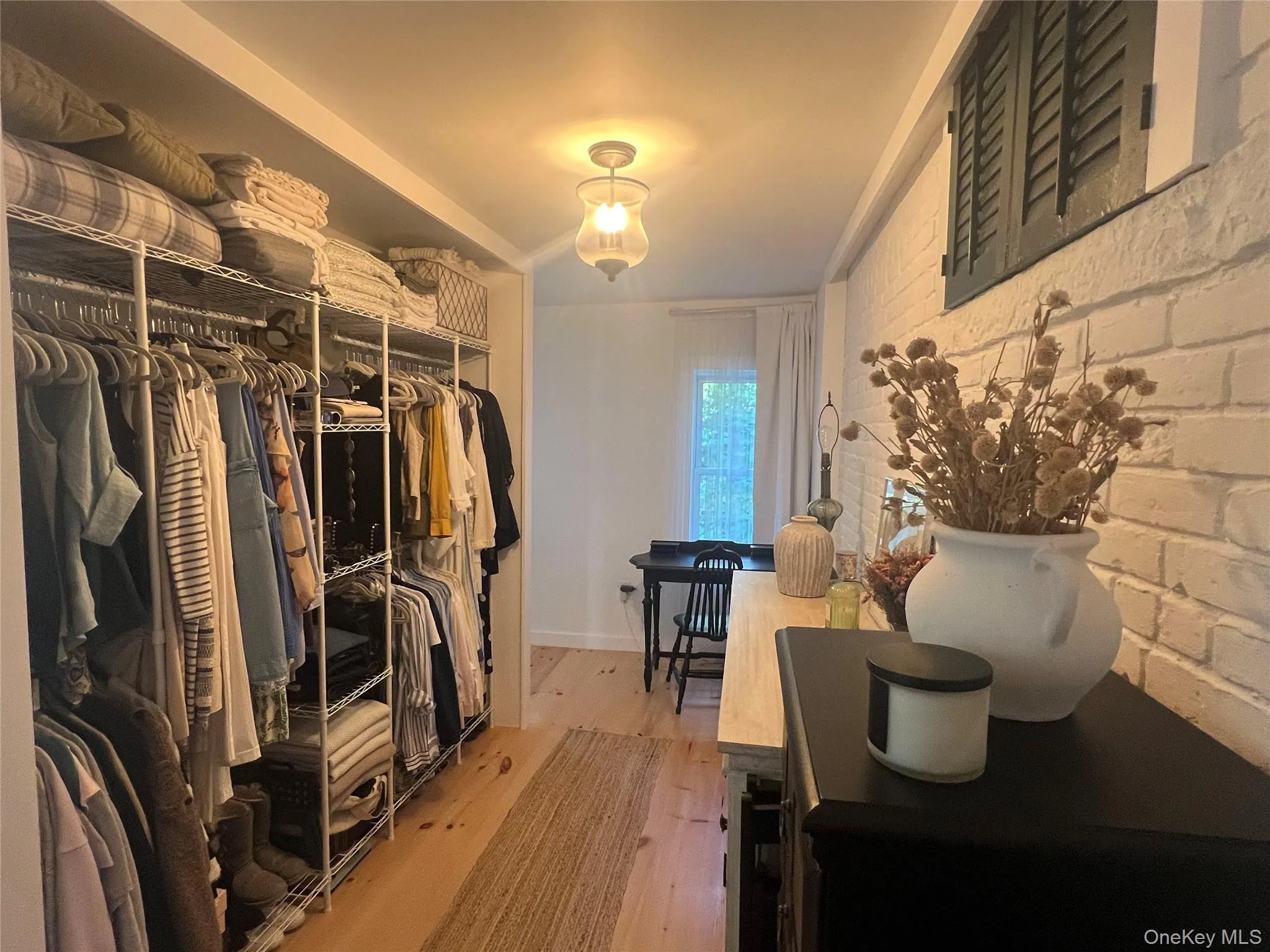 Primary BR - Spacious closet featuring light wood flooring Primary BR - Spacious closet featuring light wood flooring