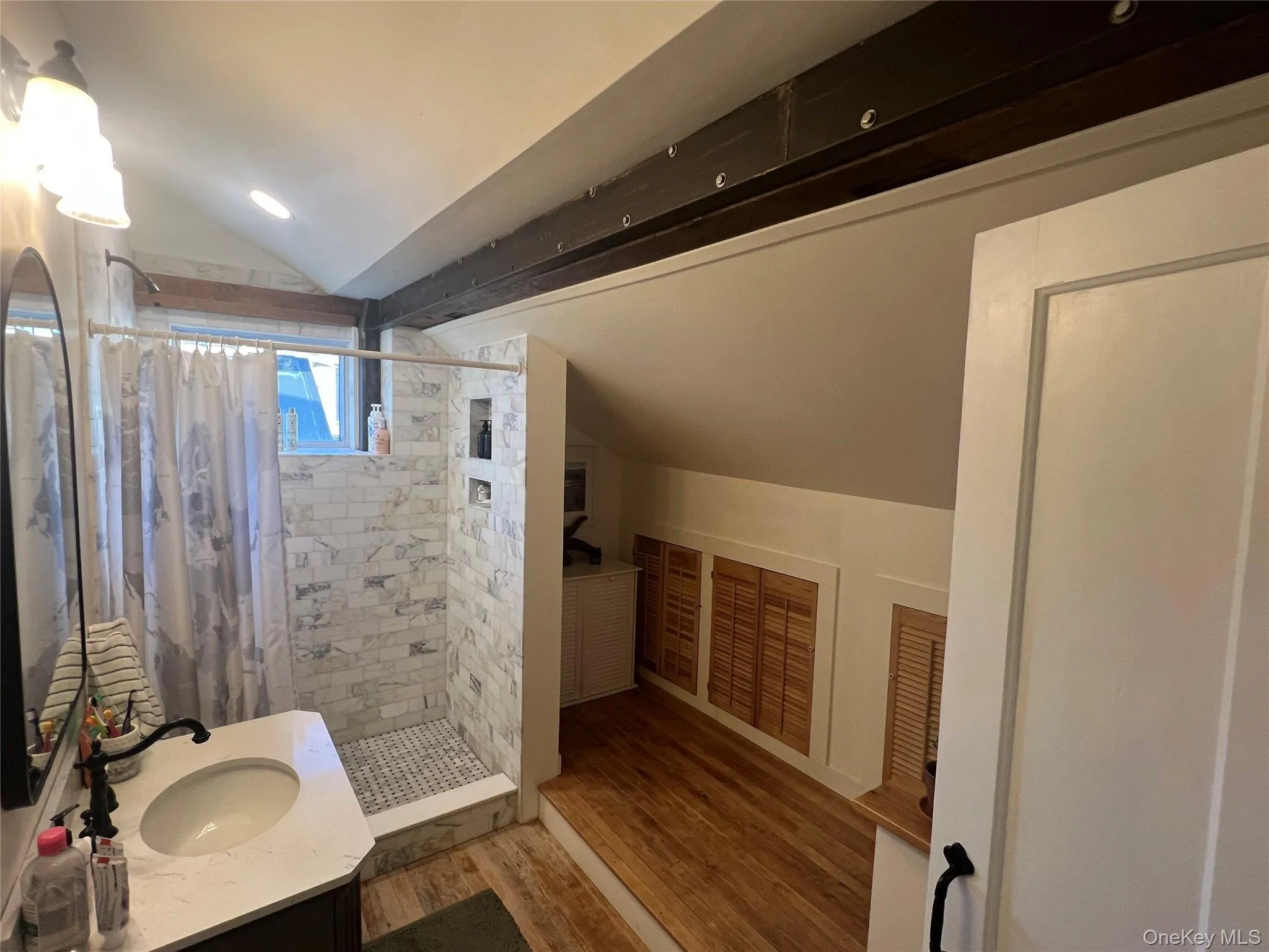 Full bathroom featuring a stall shower, vanity, wood floors, and recessed lighting Full bathroom featuring a stall shower, vanity, wood floors, and recessed lighting