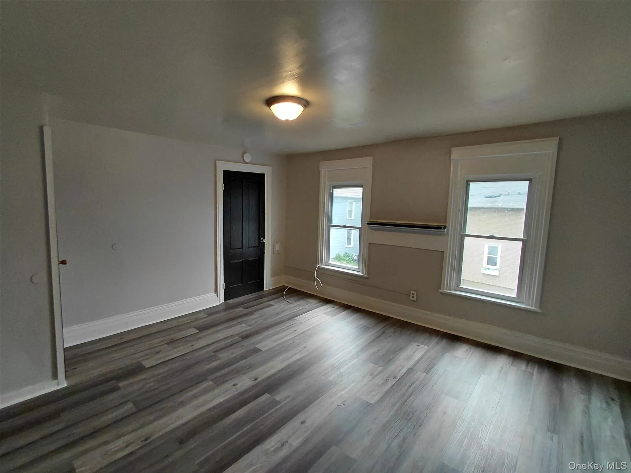 Unfurnished room featuring baseboards and wood finished floors Unfurnished room featuring baseboards and wood finished floors