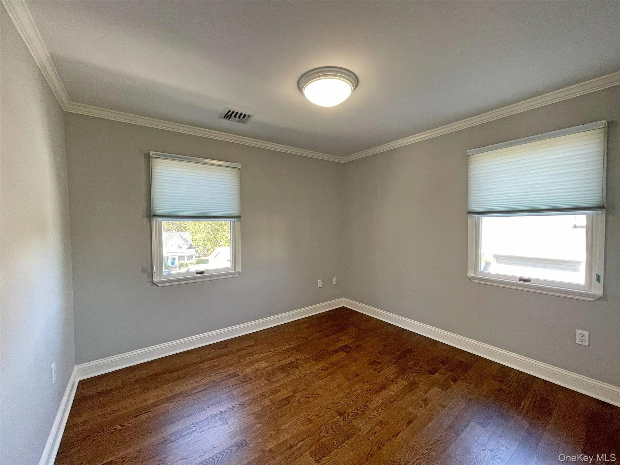 2nd Bedroom with crown molding and dark wood floors 2nd Bedroom with crown molding and dark wood floors