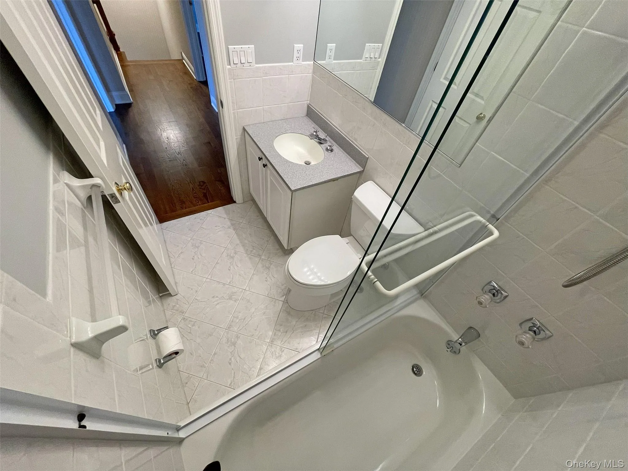 Hall bath with vanity and tile walls Hall bath with vanity and tile walls