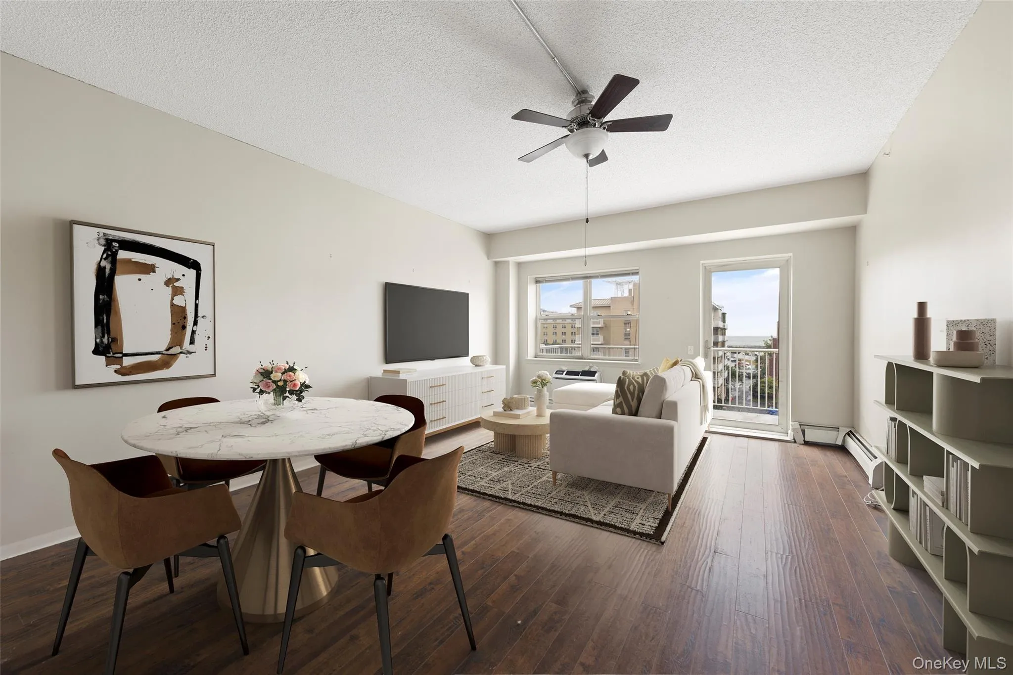 Dining space with a textured ceiling, dark wood-style floors, and a ceiling fan Dining space with a textured ceiling, dark wood-style floors, and a ceiling fan