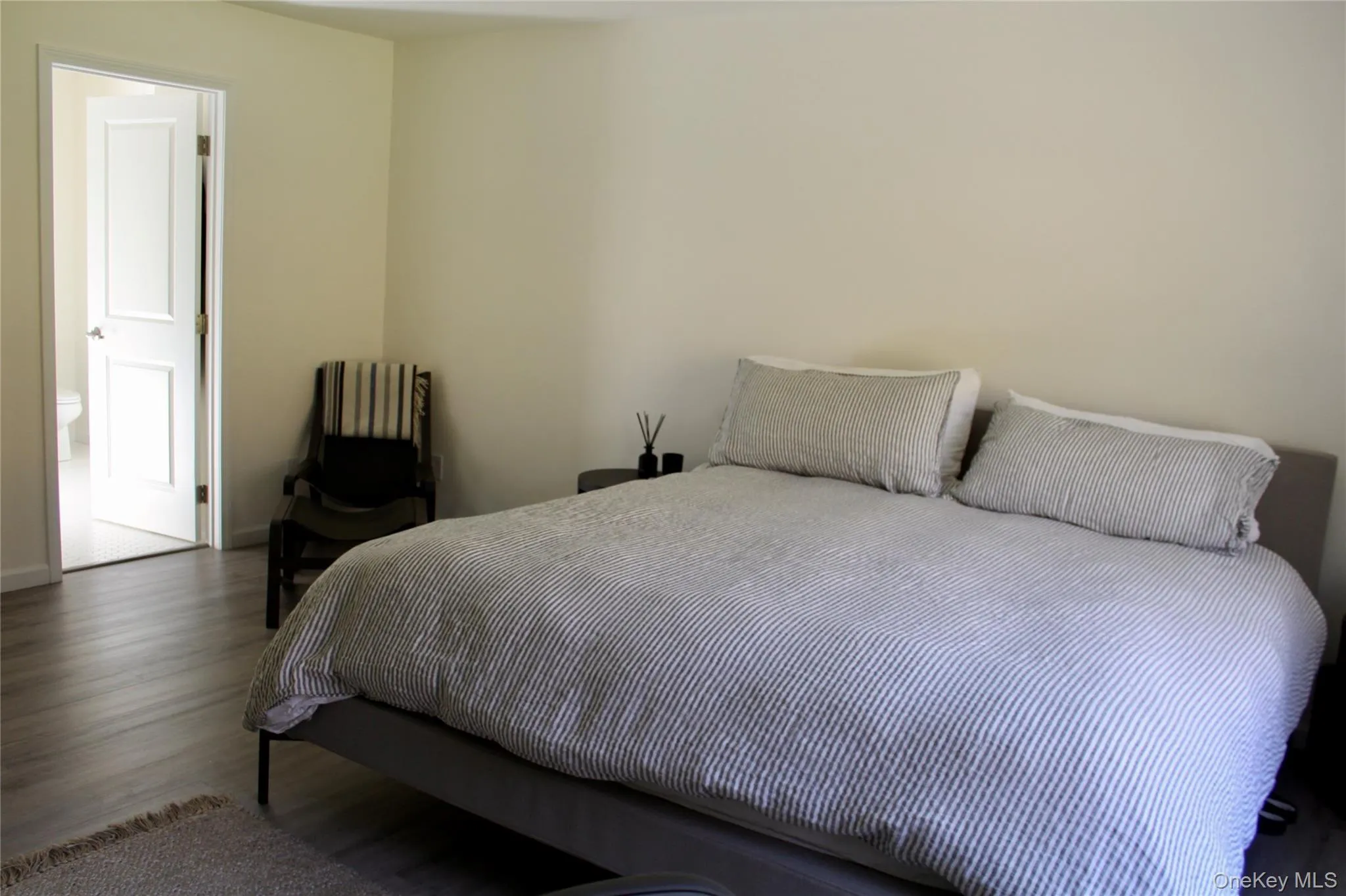 Bedroom with wood finished floors and baseboards Bedroom with wood finished floors and baseboards