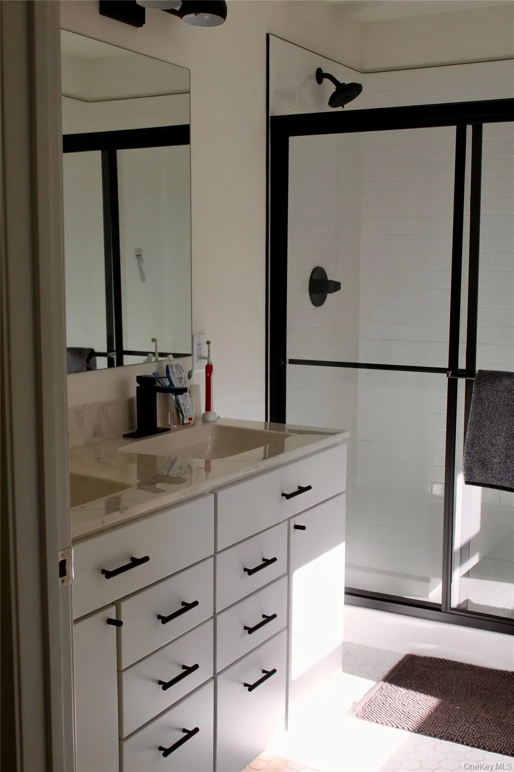 Bathroom featuring vanity and a stall shower Bathroom featuring vanity and a stall shower