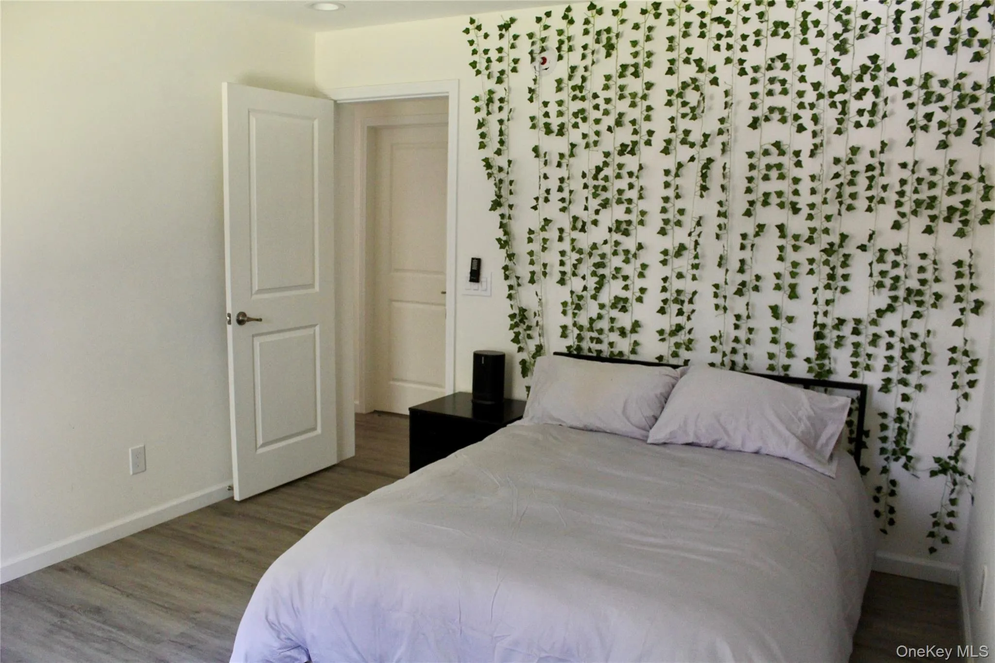 Bedroom with baseboards and wood finished floors Bedroom with baseboards and wood finished floors