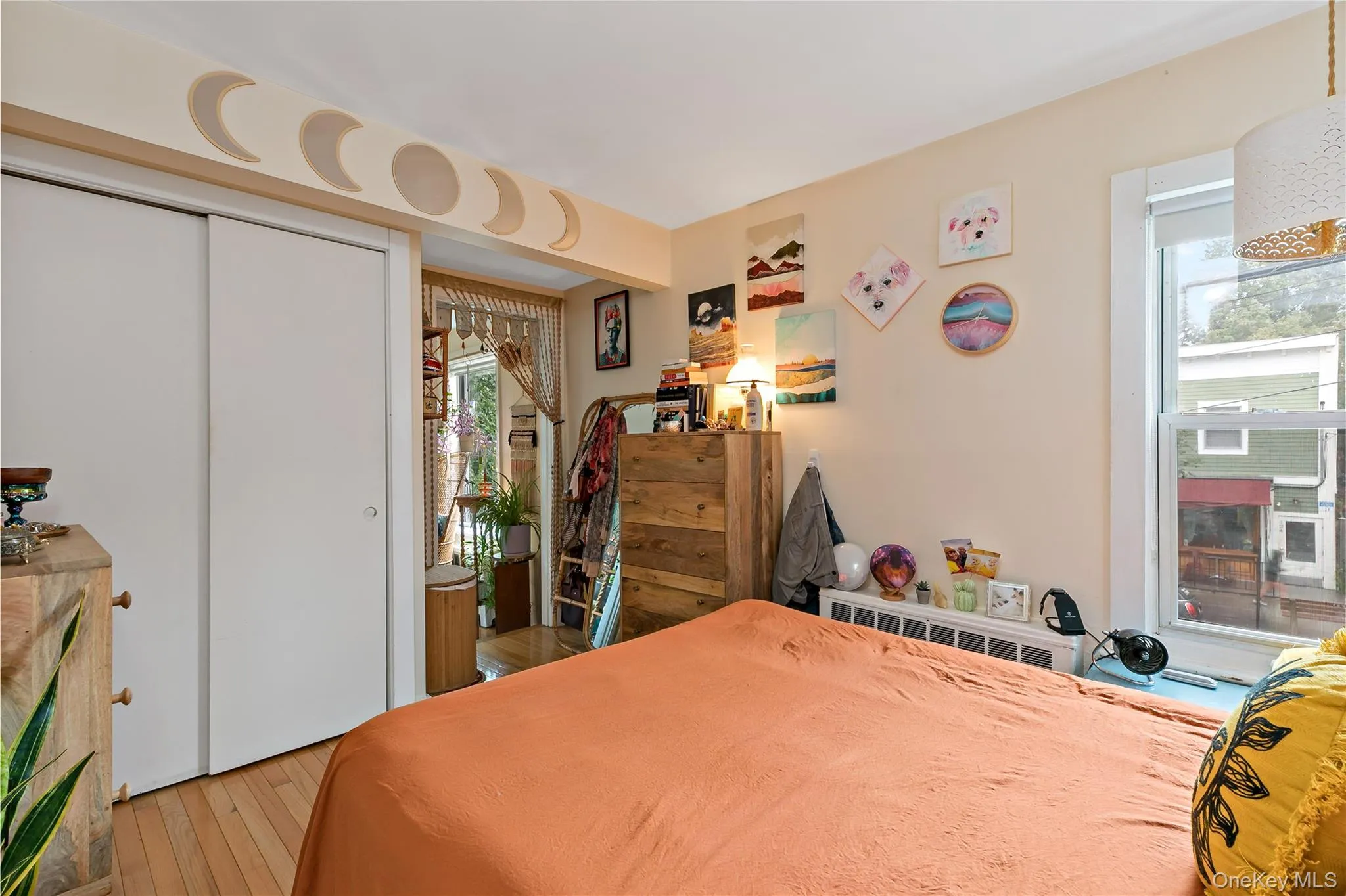 Bedroom with hardwood / wood-style floors and multiple windows Bedroom with hardwood / wood-style floors and multiple windows