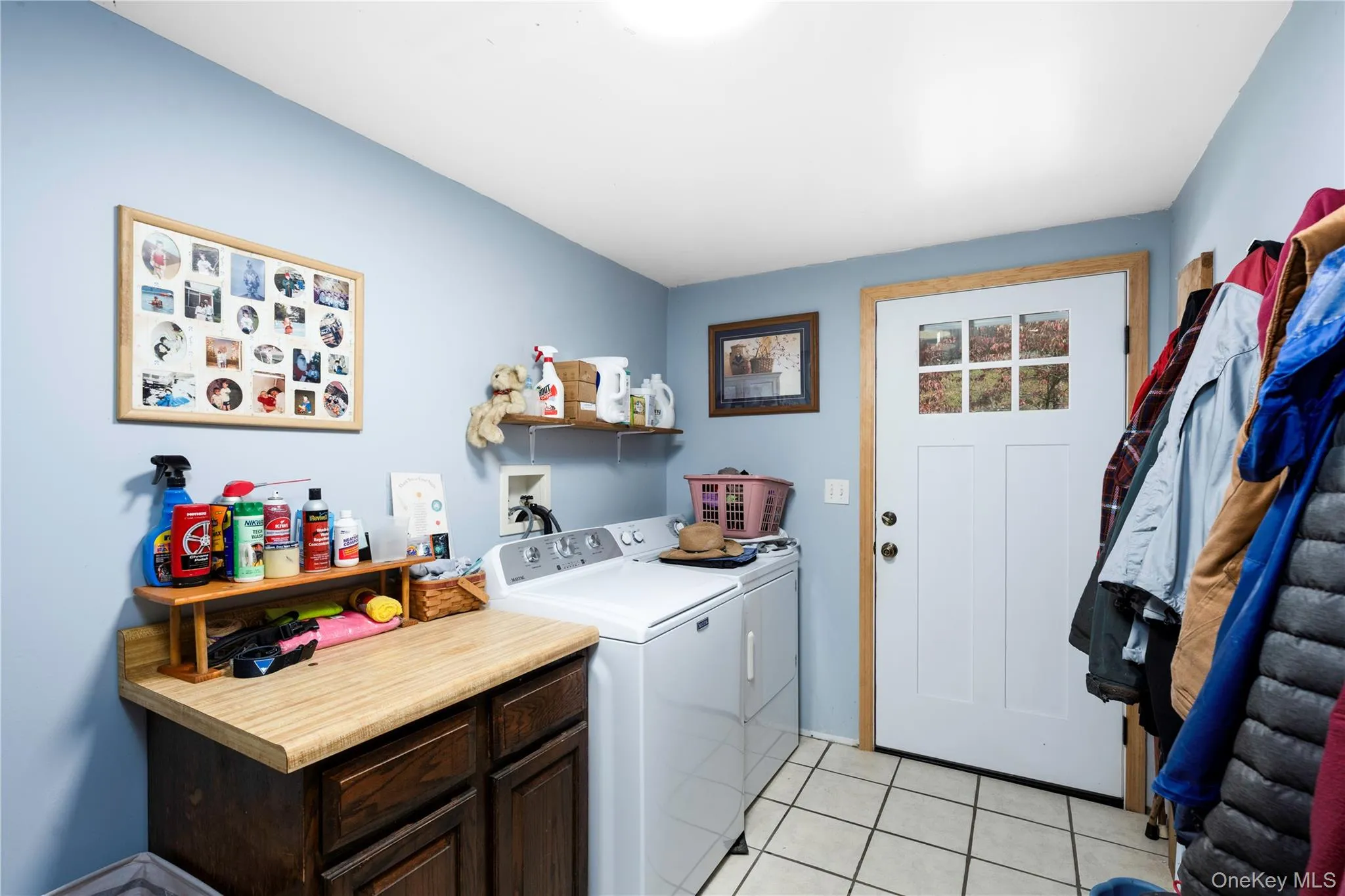 Laundry room with light tile patterned flooring and washer and dryer Laundry room with light tile patterned flooring and washer and dryer