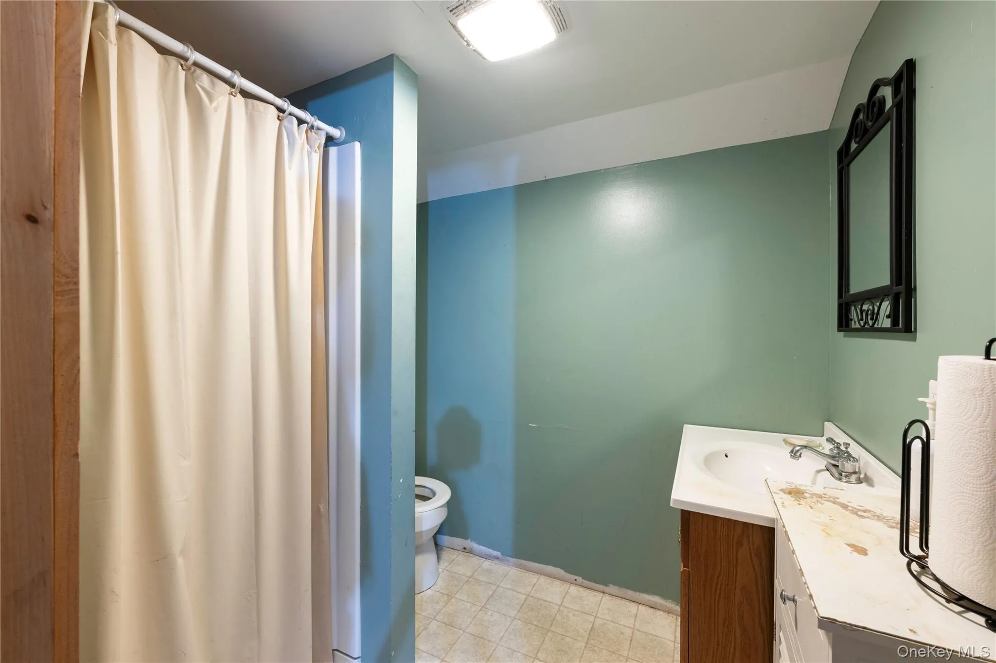 Full bath featuring vanity and curtained shower Full bath featuring vanity and curtained shower