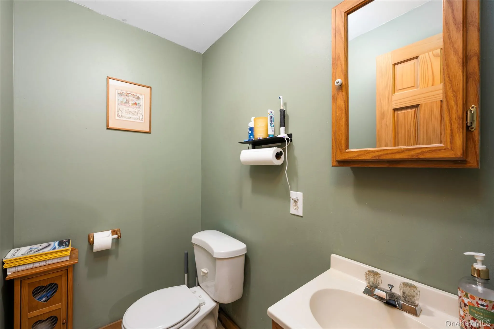 Half bathroom with toilet and vanity Half bathroom with toilet and vanity