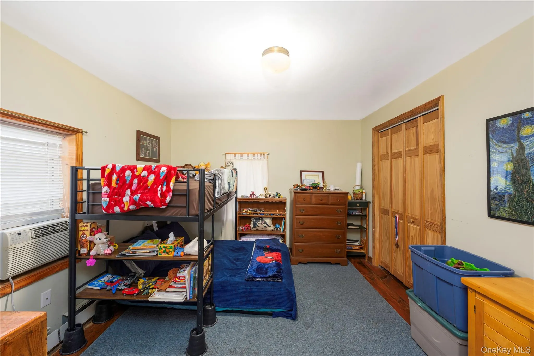 Bedroom featuring a closet, dark wood finished floors, and cooling unit Bedroom featuring a closet, dark wood finished floors, and cooling unit