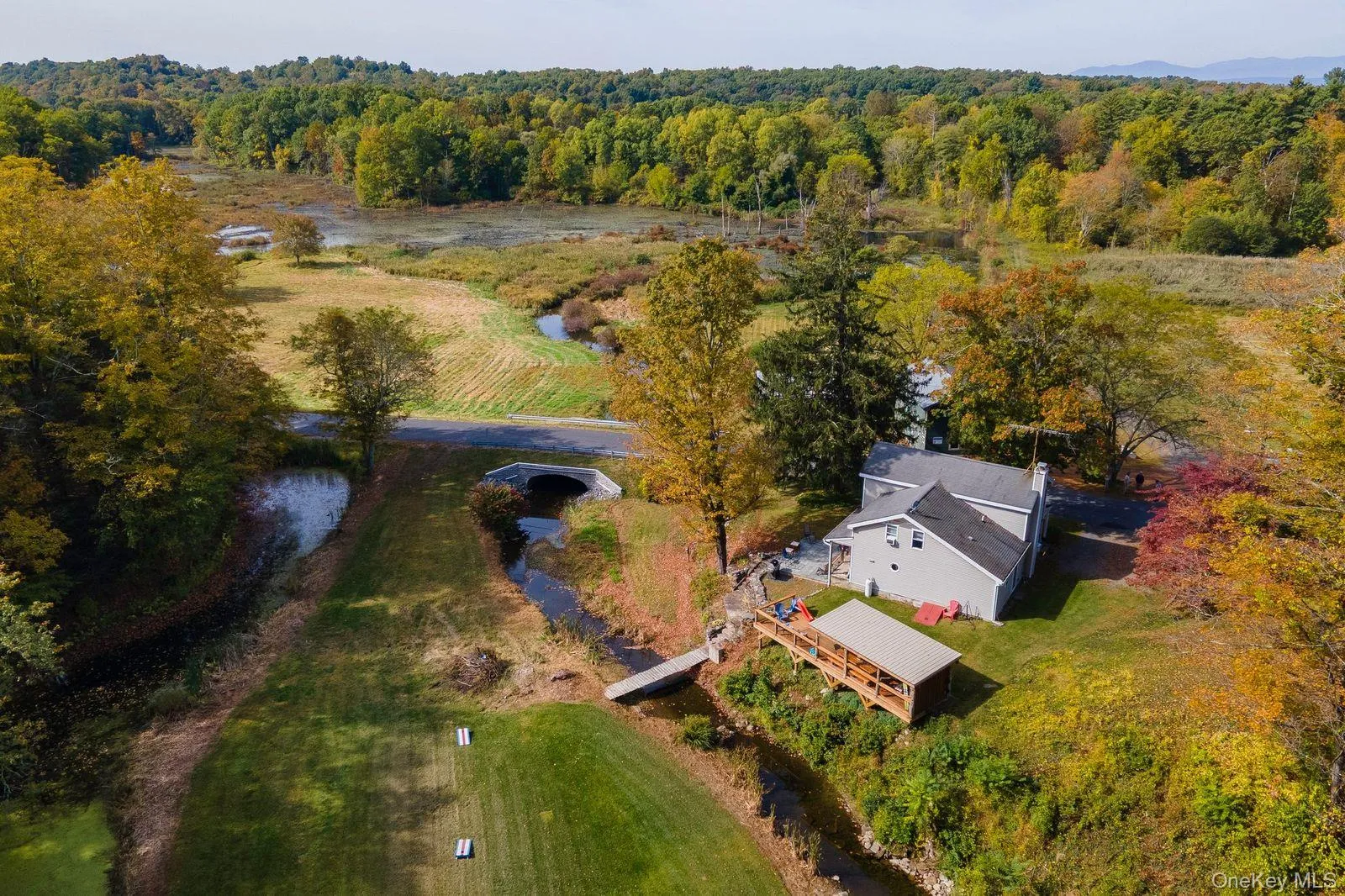 Aerial view of sparsely populated area with a heavily wooded area Aerial view of sparsely populated area with a heavily wooded area