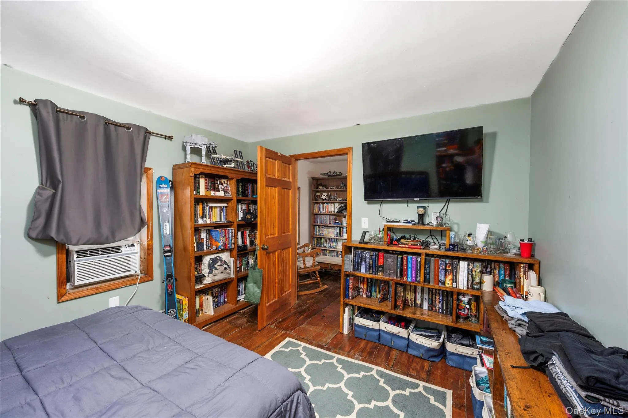 Bedroom featuring dark wood-style floors Bedroom featuring dark wood-style floors