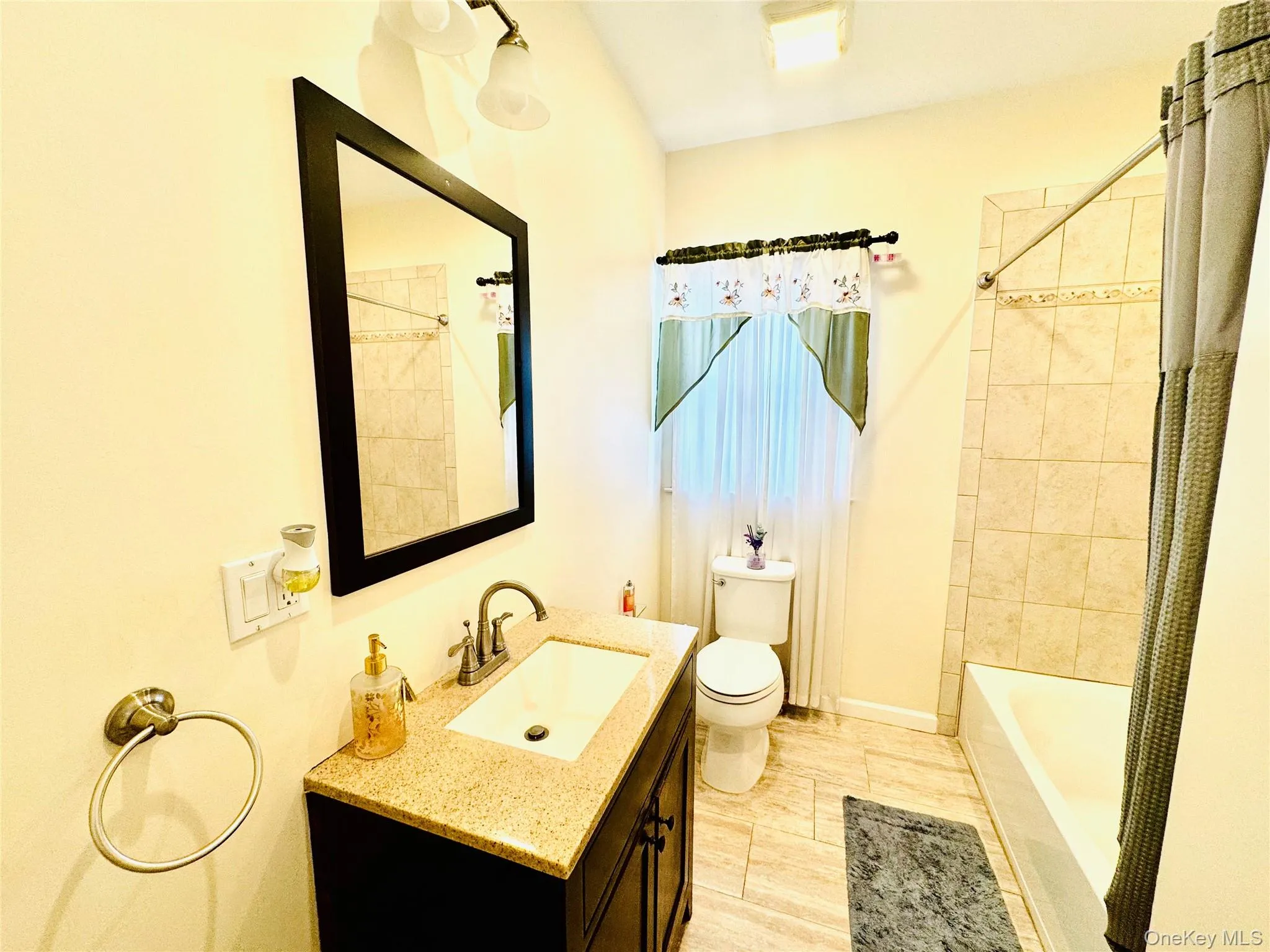 Full bath featuring vanity and shower / tub combo with curtain Full bath featuring vanity and shower / tub combo with curtain