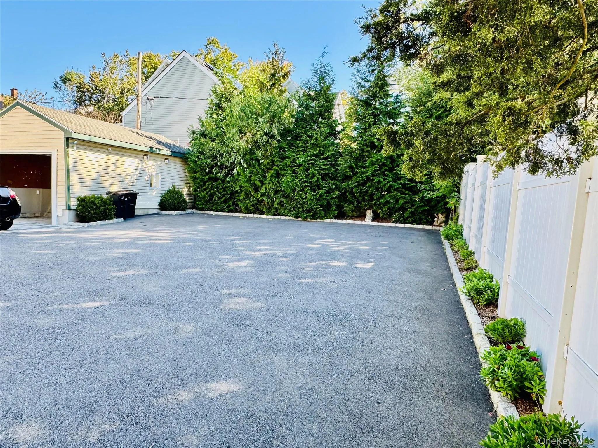 View of home's exterior featuring a garage and an outdoor structure View of home's exterior featuring a garage and an outdoor structure