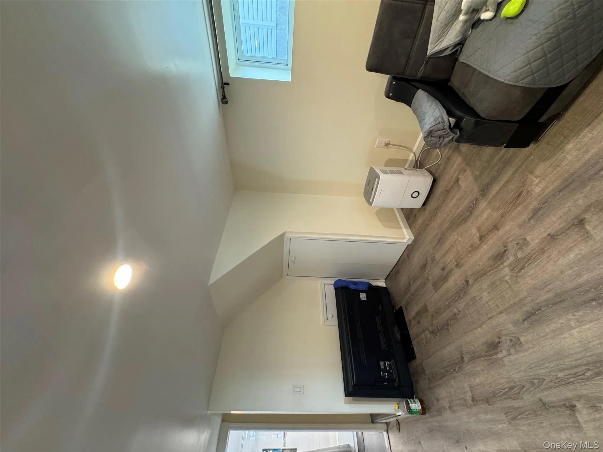 Sitting room with wood finished floors and baseboards Sitting room with wood finished floors and baseboards