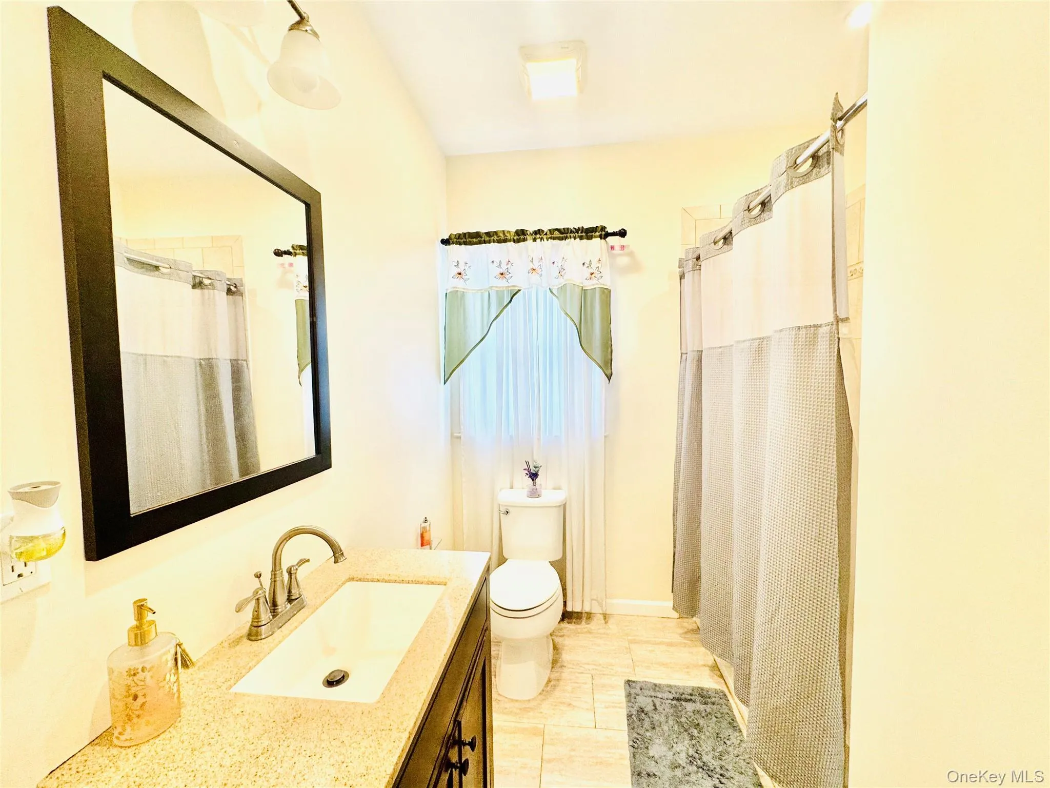 Full bath featuring vanity and curtained shower Full bath featuring vanity and curtained shower