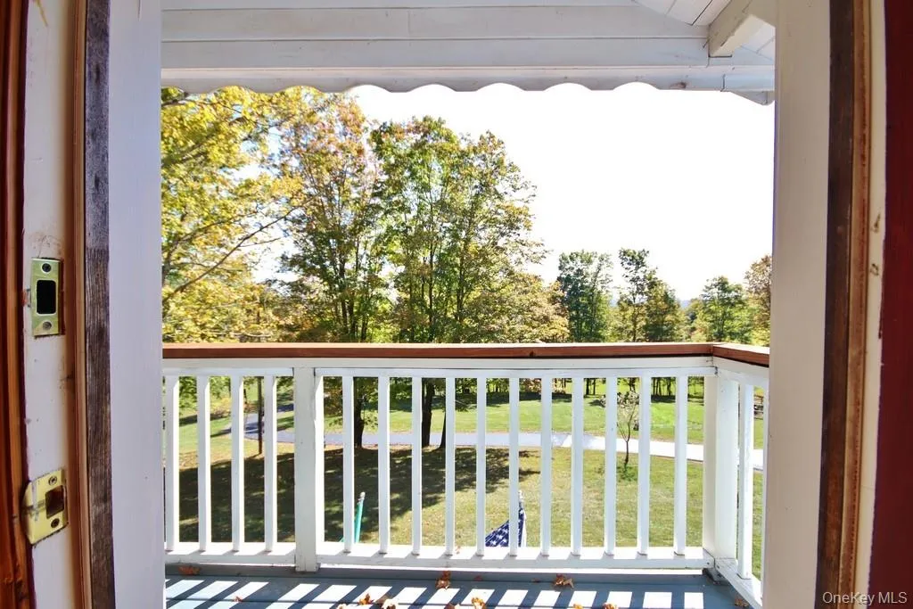 Balcony featuring view of wooded area Balcony featuring view of wooded area