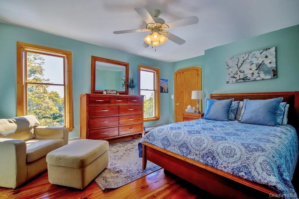 Bedroom with wood finished floors and ceiling fan Bedroom with wood finished floors and ceiling fan