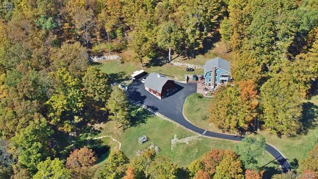 Aerial view of property and surrounding area featuring a forest Aerial view of property and surrounding area featuring a forest