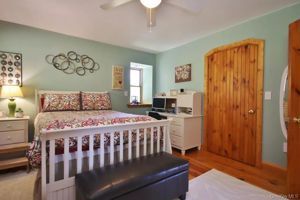 Bedroom featuring wood finished floors and a ceiling fan Bedroom featuring wood finished floors and a ceiling fan