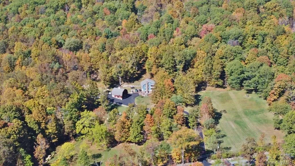 Aerial view of property and surrounding area featuring a forest Aerial view of property and surrounding area featuring a forest