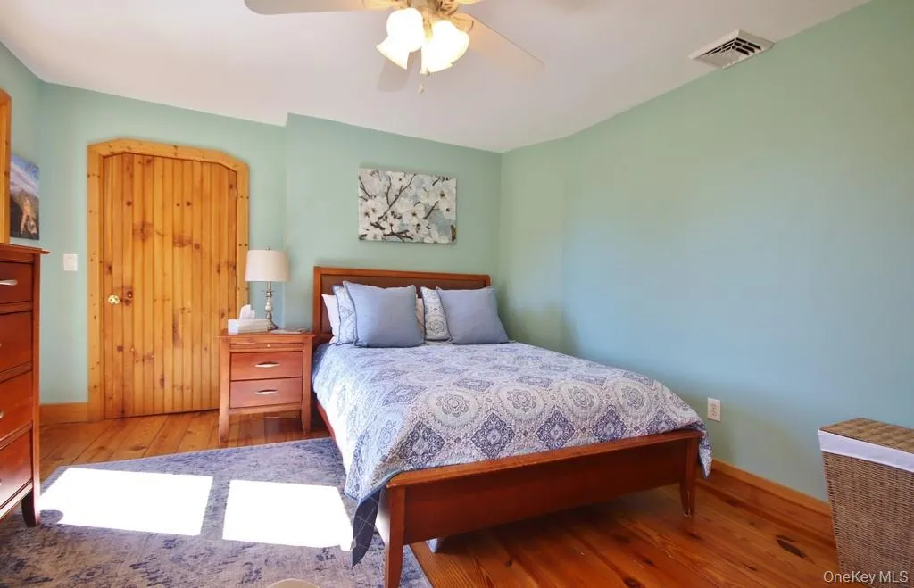 Bedroom with hardwood / wood-style floors and a ceiling fan Bedroom with hardwood / wood-style floors and a ceiling fan