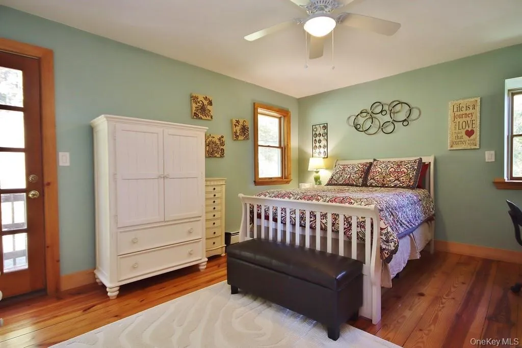 Bedroom with hardwood / wood-style flooring and a ceiling fan Bedroom with hardwood / wood-style flooring and a ceiling fan