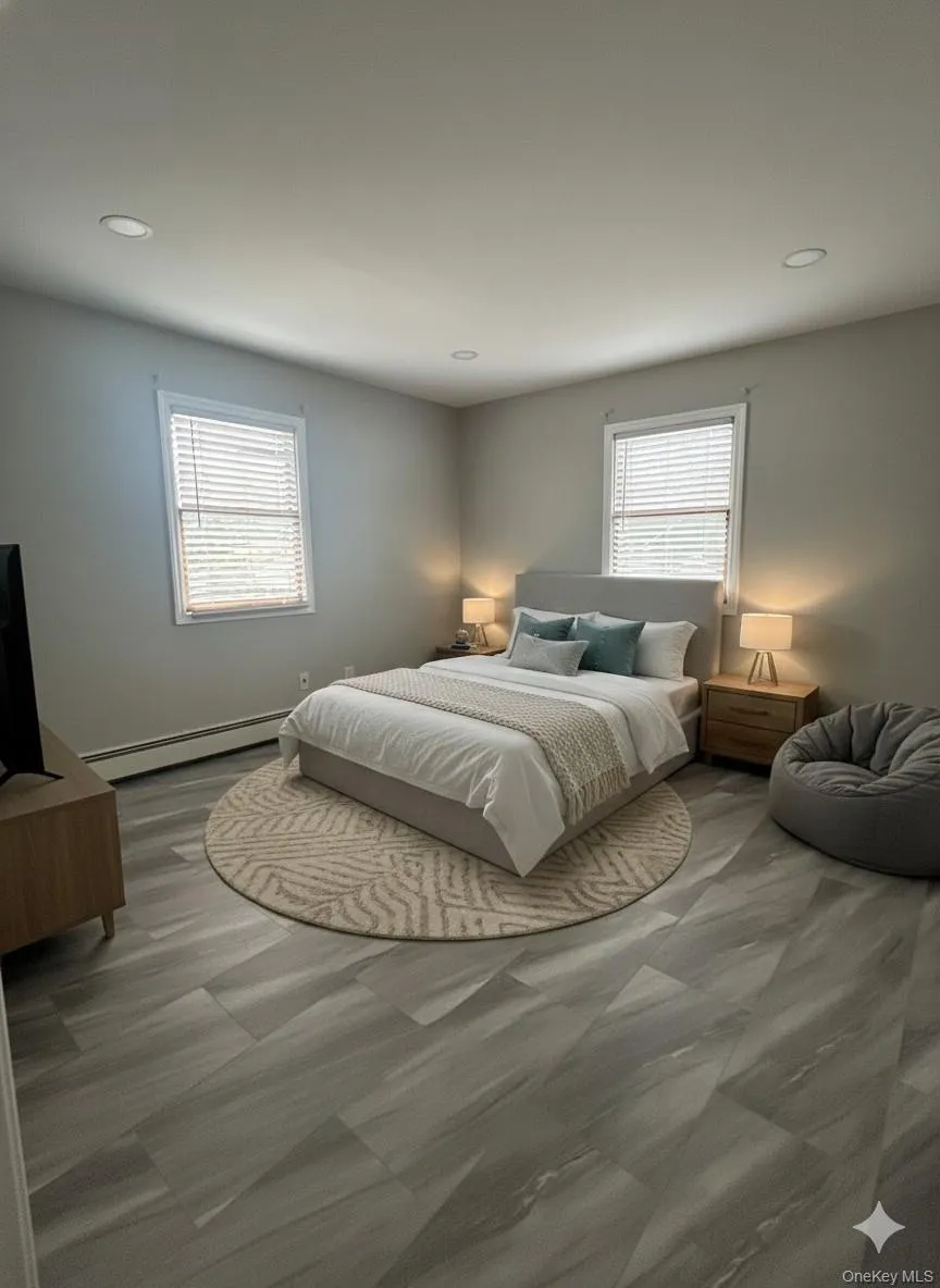 Bedroom with baseboard heating and recessed lighting Bedroom with baseboard heating and recessed lighting