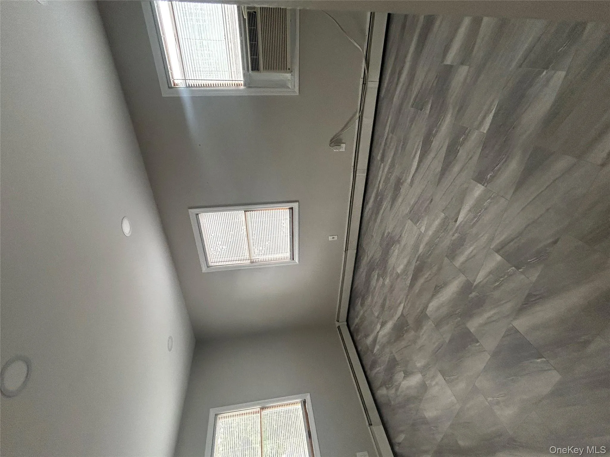 Unfurnished room featuring plenty of natural light, cooling unit, recessed lighting, and baseboard heating Unfurnished room featuring plenty of natural light, cooling unit, recessed lighting, and baseboard heating