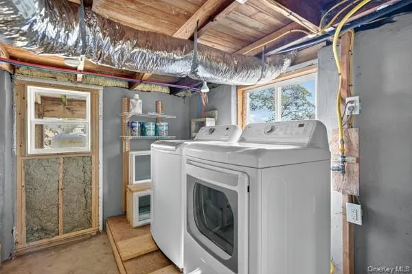 Laundry room with washer and dryer and concrete floors Laundry room with washer and dryer and concrete floors