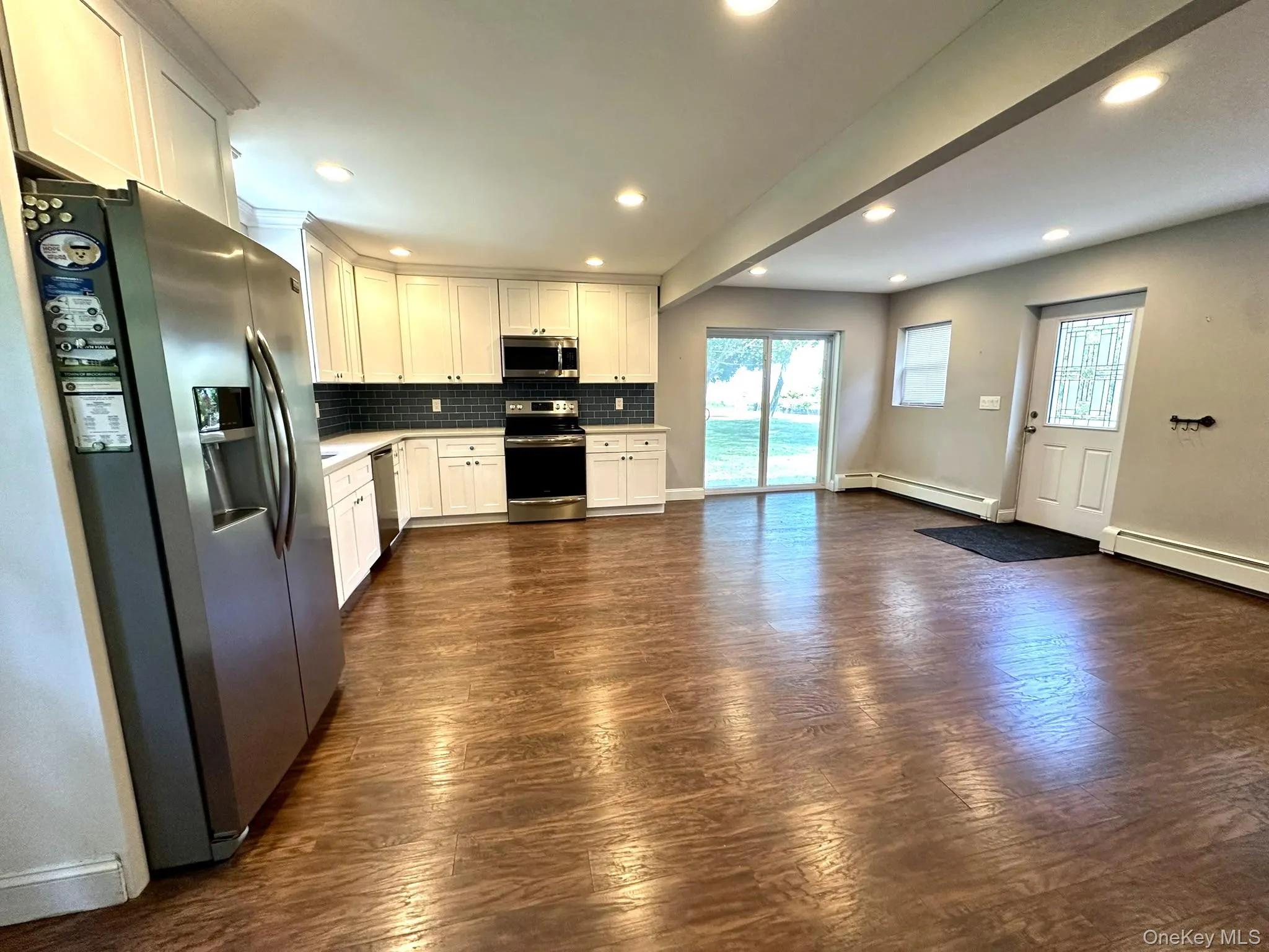 Kitchen featuring appliances with stainless steel finishes, decorative backsplash, white cabinets, healthy amount of natural light, and recessed lighting Kitchen featuring appliances with stainless steel finishes, decorative backsplash, white cabinets, healthy amount of natural light, and recessed lighting