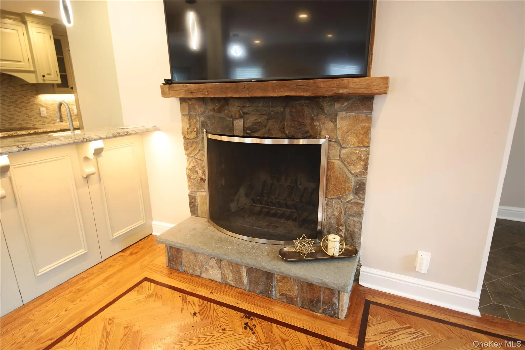 Detailed view of a stone fireplace and tasteful backsplash Detailed view of a stone fireplace and tasteful backsplash