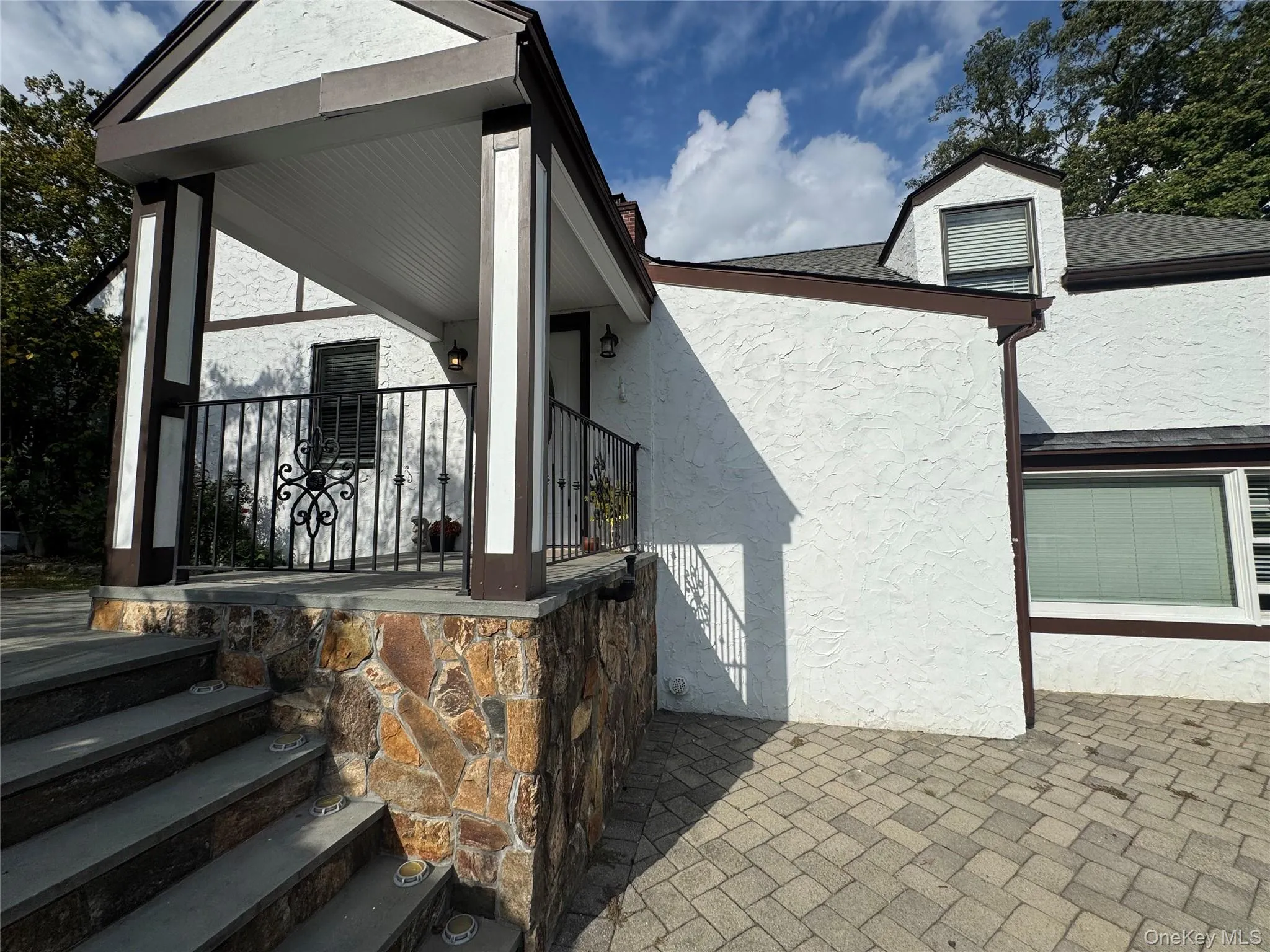 View of home's exterior with stucco siding and stone siding View of home's exterior with stucco siding and stone siding
