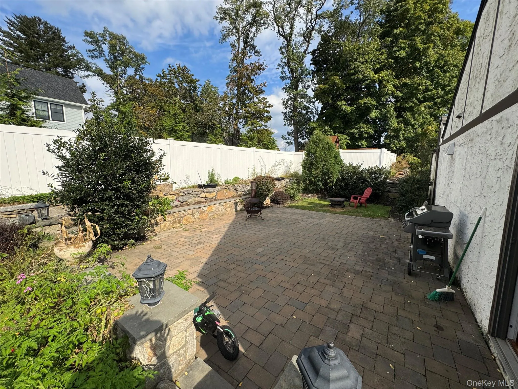 Fenced backyard featuring a patio area and area for grilling Fenced backyard featuring a patio area and area for grilling