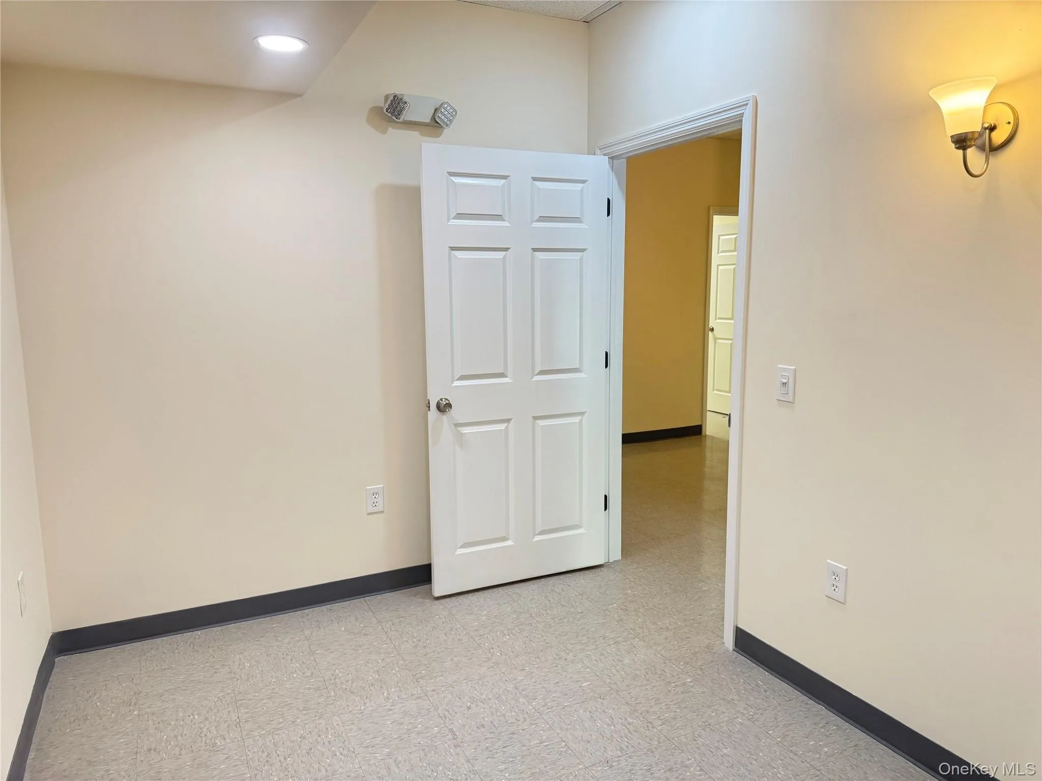 Empty room featuring baseboards and light flooring Empty room featuring baseboards and light flooring