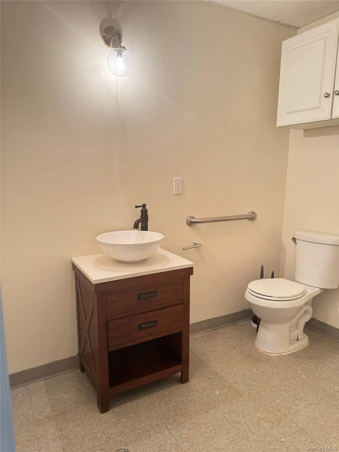 Half bathroom with baseboards and vanity Half bathroom with baseboards and vanity