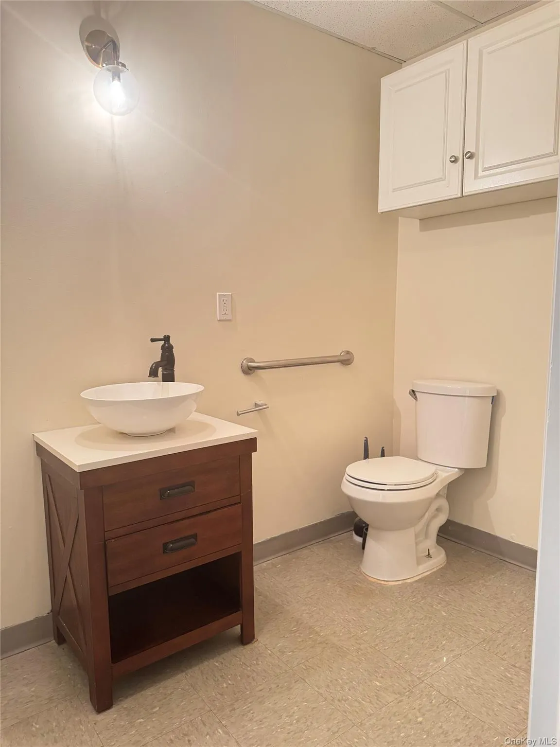 Half bathroom featuring baseboards and vanity Half bathroom featuring baseboards and vanity