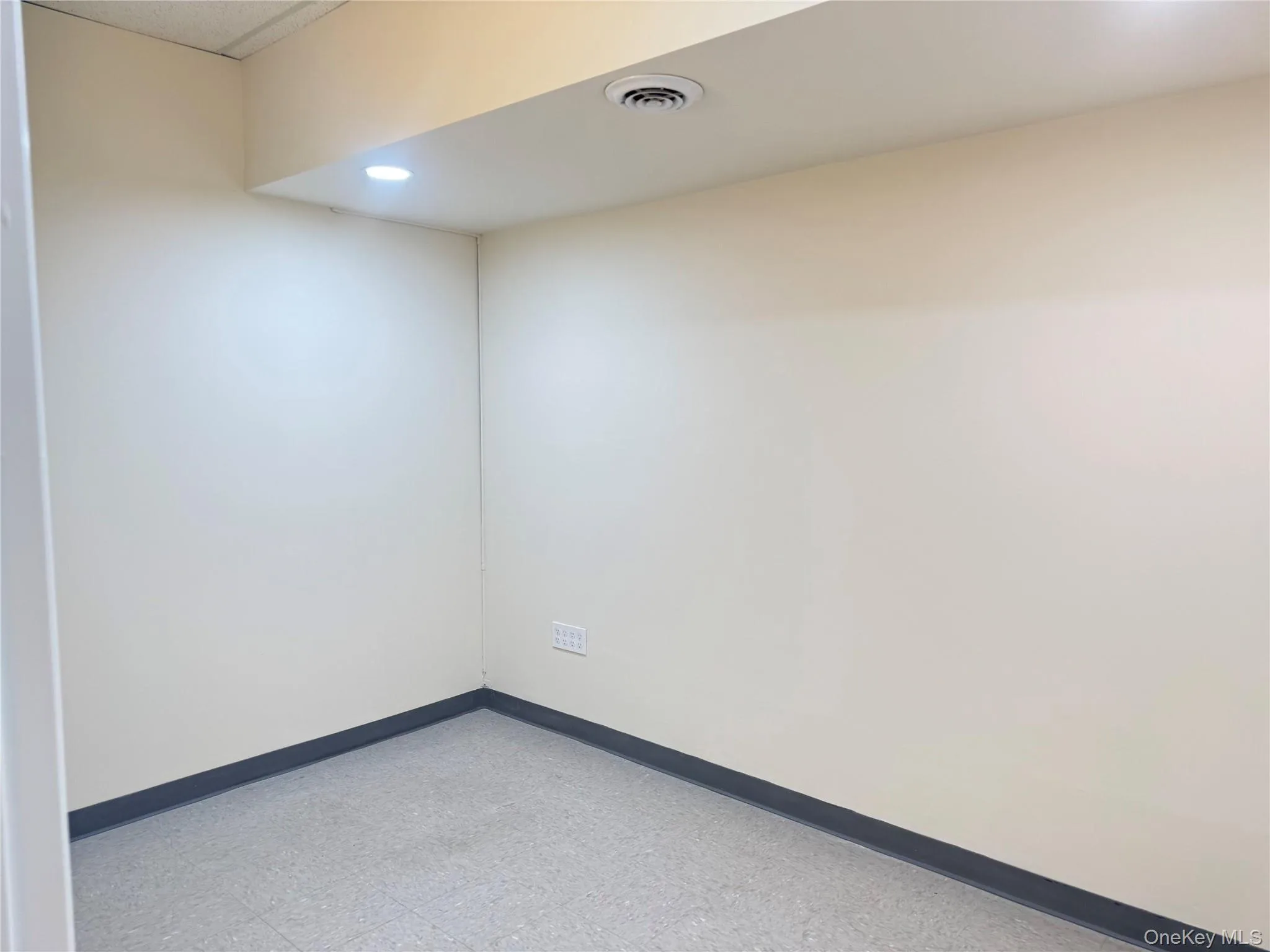 Empty room featuring tile patterned floors and recessed lighting Empty room featuring tile patterned floors and recessed lighting